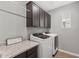 Laundry room with a countertop, cabinets above the washer and dryer at 3881 E Galveston St, Gilbert, AZ 85295
