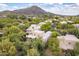 Expansive aerial view of the home, highlighting its desert surroundings and mountain views at 39017 N Habitat Cir, Cave Creek, AZ 85331