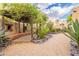 Charming backyard featuring a pergola, desert landscaping, and accent boulders at 39017 N Habitat Cir, Cave Creek, AZ 85331