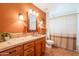 Inviting bathroom with warm toned walls, tile floors, and ample vanity space with decorative light fixture at 39017 N Habitat Cir, Cave Creek, AZ 85331