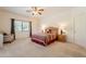 Bright bedroom featuring a ceiling fan, window and an inviting bed with patterned bedding at 39017 N Habitat Cir, Cave Creek, AZ 85331