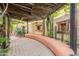 Charming courtyard featuring a pergola, rustic wall design and desert landscaping for a tranquil outdoor experience at 39017 N Habitat Cir, Cave Creek, AZ 85331