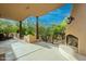 Covered patio featuring a fireplace, desert views, and ample seating creates a relaxing outdoor living space at 39017 N Habitat Cir, Cave Creek, AZ 85331