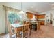 Bright dining area off the kitchen with a wooden table, built-in shelves, and a large window overlooking the landscape at 39017 N Habitat Cir, Cave Creek, AZ 85331