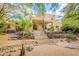 Stunning two-story home with a grand staircase and lush desert landscaping, perfect for outdoor living at 39017 N Habitat Cir, Cave Creek, AZ 85331