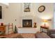 Living room featuring a cozy fireplace with tile surround, decorative artwork, and a Southwest accent at 39017 N Habitat Cir, Cave Creek, AZ 85331