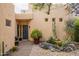 This home features a blue front door, stone pathway, and drought-resistant landscaping, creating inviting curb appeal at 39017 N Habitat Cir, Cave Creek, AZ 85331