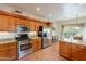 Well-equipped kitchen with stainless steel appliances, oak cabinets, granite countertops and tiled floors at 39017 N Habitat Cir, Cave Creek, AZ 85331