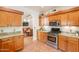 Well-equipped kitchen with granite countertops, wooden cabinets, and stainless steel appliances at 39017 N Habitat Cir, Cave Creek, AZ 85331