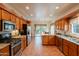 Spacious kitchen with stainless steel appliances, granite countertops, wooden cabinets, and tile flooring at 39017 N Habitat Cir, Cave Creek, AZ 85331