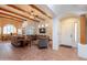 Inviting living room with exposed wood beams, tile flooring, and comfortable seating for a cozy gathering space at 39017 N Habitat Cir, Cave Creek, AZ 85331