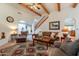 Warm and inviting living room featuring wood beams, a cozy seating area, and a rustic charm at 39017 N Habitat Cir, Cave Creek, AZ 85331