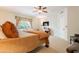 Bedroom features plush carpeting, neutral walls, a ceiling fan, and a large window at 39017 N Habitat Cir, Cave Creek, AZ 85331