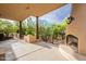 Covered patio with an outdoor fireplace, offering an inviting space for entertaining and relaxing at 39017 N Habitat Cir, Cave Creek, AZ 85331