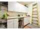 Functional room offers ample storage with white cabinets and a counter, paired with convenient shelving at 39017 N Habitat Cir, Cave Creek, AZ 85331