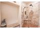 Modern shower features tile surround, pebble floor, and built-in bench for a spa-like experience at 39017 N Habitat Cir, Cave Creek, AZ 85331