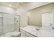 Bright bathroom with a white vanity, shower with glass door, and large mirror, creating a clean, modern look at 3936 E San Jose St, San Tan Valley, AZ 85143