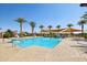 Community pool with palm trees, offering a refreshing oasis for residents to relax and enjoy the outdoors at 3936 E San Jose St, San Tan Valley, AZ 85143