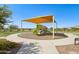 Community playground shaded by a canopy, providing a safe and fun play area for children at 3936 E San Jose St, San Tan Valley, AZ 85143