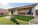Relaxing backyard oasis with a covered patio, artificial turf, and a charming fountain at 40713 N Citrus Canyon Trl, Phoenix, AZ 85086