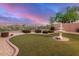 Backyard oasis featuring manicured landscaping, a water fountain, and decorative rock at 40713 N Citrus Canyon Trl, Phoenix, AZ 85086