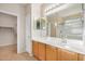 Bathroom with double sink vanity, ample lighting, and a large mirror reflecting the glass-enclosed shower at 40713 N Citrus Canyon Trl, Phoenix, AZ 85086