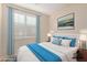 Inviting bedroom with white headboard, shuttered window, and bright artwork; perfect for relaxation at 40713 N Citrus Canyon Trl, Phoenix, AZ 85086