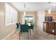 Dining area featuring tile floors, modern lighting, with a sliding glass door to the backyard and modern table set at 40713 N Citrus Canyon Trl, Phoenix, AZ 85086