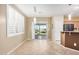 Dining area featuring tile floors, modern lighting, with a sliding glass door to the backyard at 40713 N Citrus Canyon Trl, Phoenix, AZ 85086