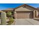Exterior of home featuring attached two car garage, desert landscaping and tile roof at 40713 N Citrus Canyon Trl, Phoenix, AZ 85086