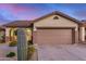 Exterior of home featuring attached two car garage, desert landscaping and tile roof at 40713 N Citrus Canyon Trl, Phoenix, AZ 85086