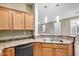 Kitchen featuring a breakfast bar with a stainless steel sink, with wood cabinets, and views to the backyard at 40713 N Citrus Canyon Trl, Phoenix, AZ 85086