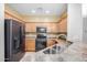 Modern kitchen with stainless steel appliances and maple cabinetry, perfect for cooking and entertaining at 40713 N Citrus Canyon Trl, Phoenix, AZ 85086