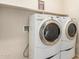 A laundry room featuring a front loading washer and dryer set at 40713 N Citrus Canyon Trl, Phoenix, AZ 85086