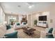 Bright living room featuring neutral walls, modern furniture, ceiling fan, and an open floor plan to dining area at 40713 N Citrus Canyon Trl, Phoenix, AZ 85086