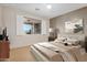 Stylishly staged main bedroom with a large window featuring plantation shutters with backyard views at 40713 N Citrus Canyon Trl, Phoenix, AZ 85086