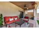 Covered patio with a ceiling fan and comfortable seating, perfect for outdoor relaxation at 40713 N Citrus Canyon Trl, Phoenix, AZ 85086