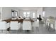 Open concept dining and living area featuring a modern table with white chairs and neutral decor at 4227 E Kolin Ln, San Tan Valley, AZ 85143