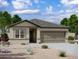 Charming single-story home with a two-car garage and a low maintenance desert landscaped front yard at 4227 E Kolin Ln, San Tan Valley, AZ 85143
