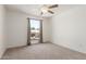A well lit bedroom features neutral carpet and a window with stylish curtains at 4803 W Harmont Dr, Glendale, AZ 85302