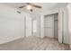 This bedroom has neutral carpet and a closet that provides ample storage space at 4803 W Harmont Dr, Glendale, AZ 85302
