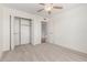 Bedroom featuring a closet and neutral carpet for comfort and convenience at 4803 W Harmont Dr, Glendale, AZ 85302