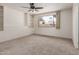 Bedroom with neutral carpet, built-in shelves, and a window at 4803 W Harmont Dr, Glendale, AZ 85302