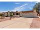 Single level home with a neutral color scheme, rock landscaping, and a two car garage at 4803 W Harmont Dr, Glendale, AZ 85302