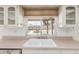 Kitchen sink overlooking the backyard pool at 4803 W Harmont Dr, Glendale, AZ 85302