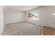 Bright living room with neutral carpet, ample natural light, and an open floorplan at 4803 W Harmont Dr, Glendale, AZ 85302
