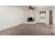Bright living room with neutral carpet, a corner fireplace, and a ceiling fan at 4803 W Harmont Dr, Glendale, AZ 85302
