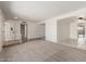 Bright living room with neutral carpet, ample natural light, and an open floorplan at 4803 W Harmont Dr, Glendale, AZ 85302
