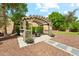 Beautiful backyard featuring a pergola, firepit, stone pathway, and manicured landscaping at 5136 W Trotter Trl, Phoenix, AZ 85083