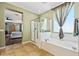 Bathroom with tub, shower, and a bedroom view at 5136 W Trotter Trl, Phoenix, AZ 85083